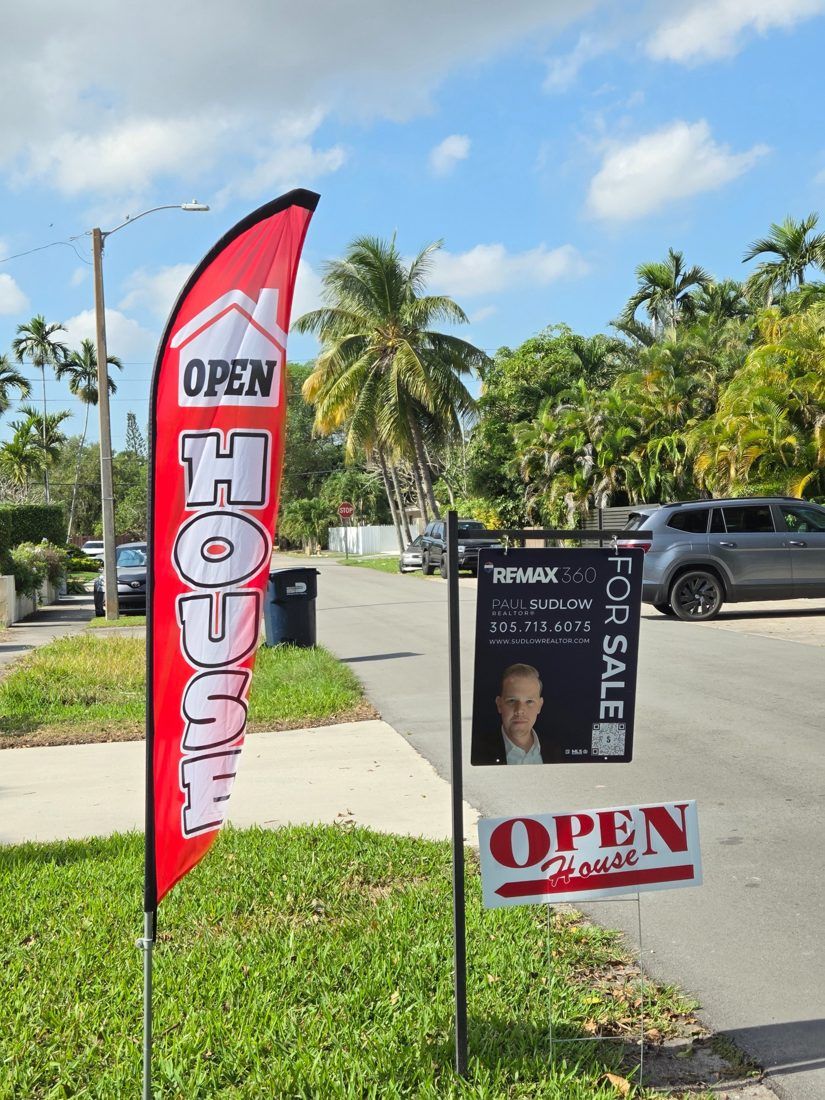 Paul Sudlow RE/MAX 360 for-sale sign and open house flag on a Miami street